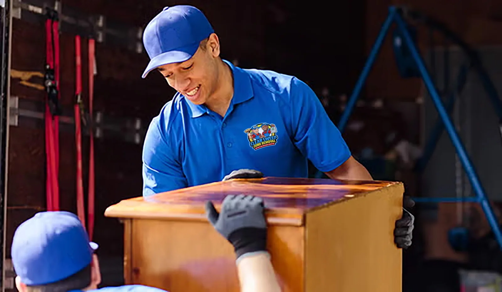 Professional junk removal team loading a large appliance onto a truck in Kissimmee FL